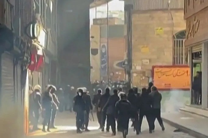 তেহরানের বাজারে বিক্ষোভকারীদের ছত্রভঙ্গ করতে নিরাপত্তা বাহিনীর সদস্যরা কাঁদানে গ্যাসের শেল ছোড়েন