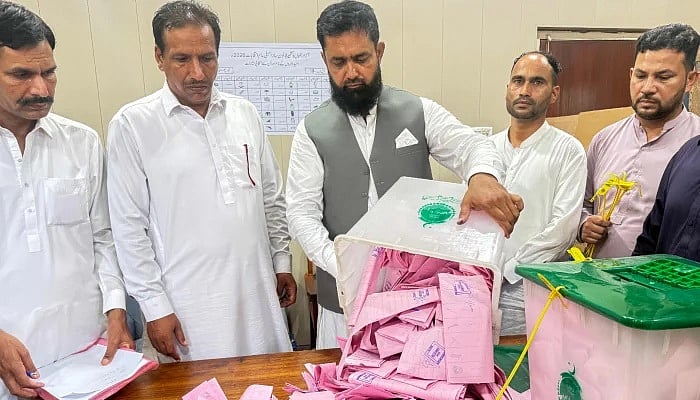 আজাদ জম্মু ও কাশ্মীরের (এজেকে) আইনসভা নির্বাচনের প্রথম ধাপের ভোট শেষে মিরপুরের একটি ভোটকেন্দ্রে ব্যালট বাক্স খুলে ভোট গণনা করছেন এক নির্বাচন কর্মকর্তা
