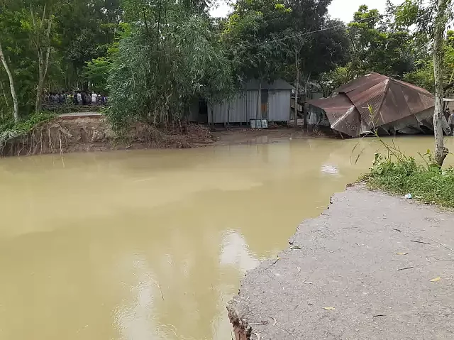 More than fifty housed are inundated in a few minutes as the embankment is damaged by the flood water in Faridpur's Sadar upazila is destroyed by flood water on 19 July 2020.