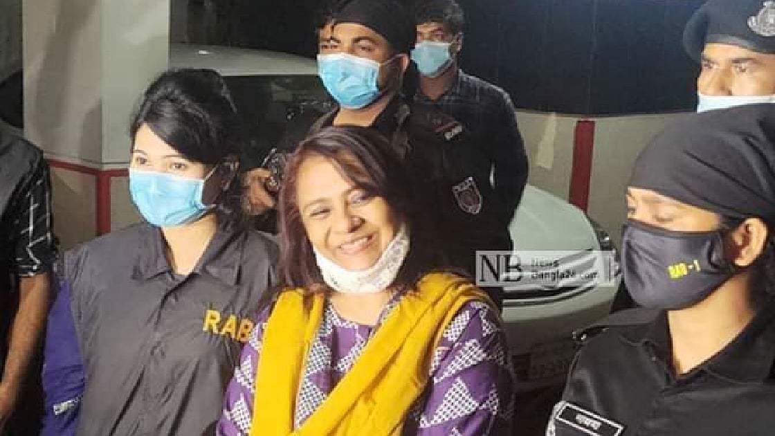 RAB personnel escort Helena Jahangir after detaining the businessperson from her residence in Dhaka’s Gulshan on Thursday night