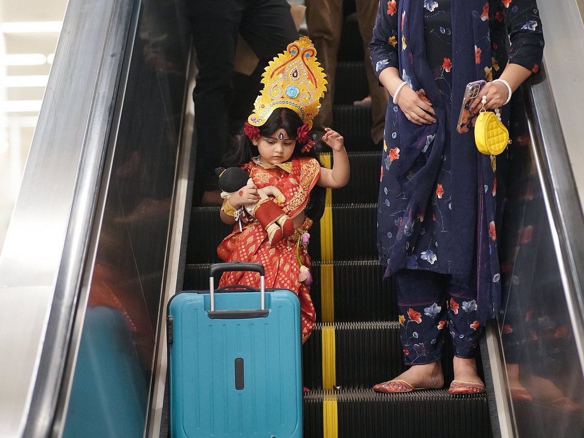 Cute little ‘Durga’ walking around Dhaka metro rail station