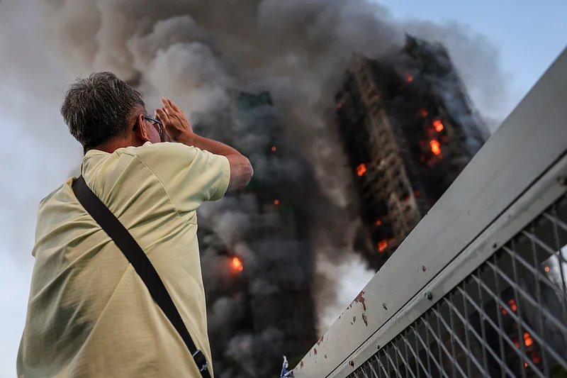 Wong, 71, reacts after saying his wife is trapped inside Wang Fuk Court during a major fire, in Tai Po, Hong Kong, China, 26 November 2025. 