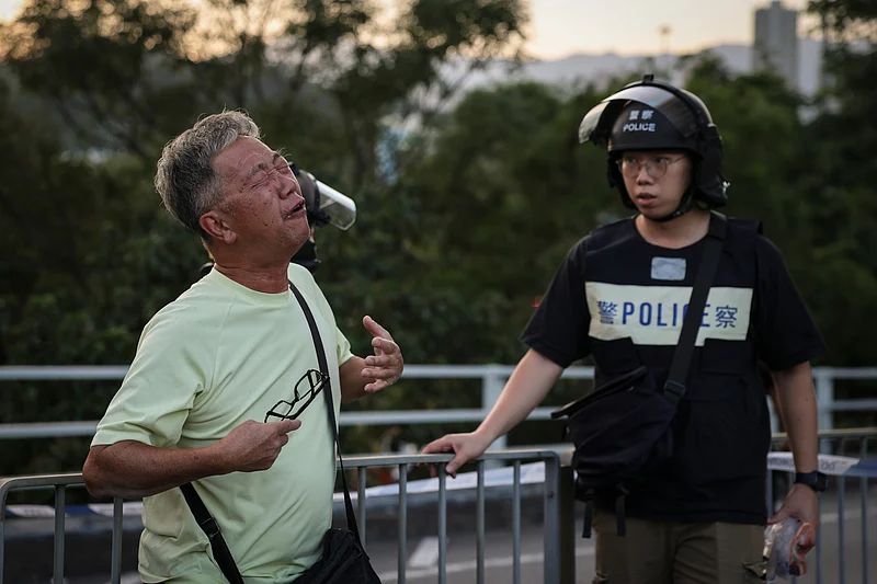Wong, 71, reacts after saying his wife is trapped inside Wang Fuk Court during a major fire, in Tai Po, Hong Kong, China, 26 November 2025.