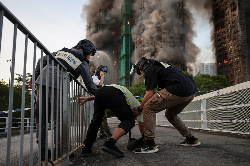 Wong, 71, reacts after saying his wife is trapped inside Wang Fuk Court during a major fire, in Tai Po, Hong Kong, China, 26 November 2025. 