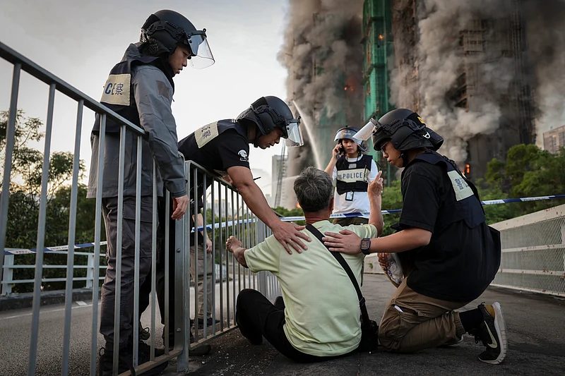 Wong, 71, reacts after saying his wife is trapped inside Wang Fuk Court during a major fire, in Tai Po, Hong Kong, China, 26 November 2025. 