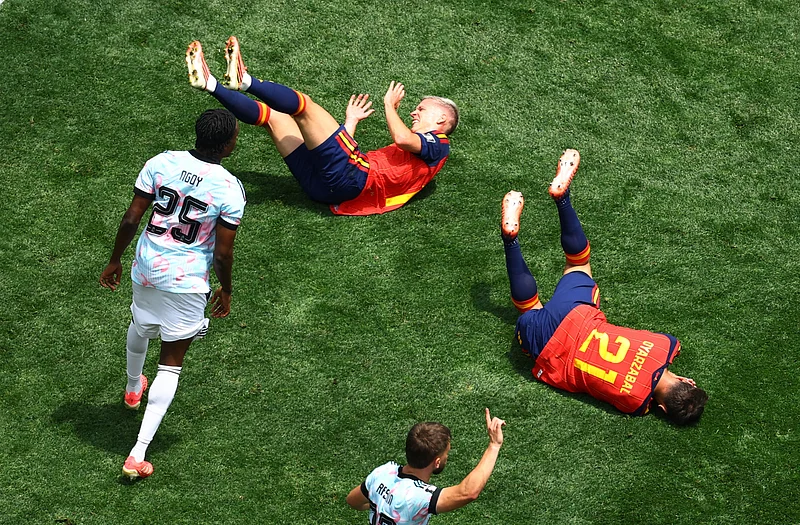 
Spain's Dani Olmo and Mikel Oyarzabal react as Belgium's Nathan Ngoy looks on 