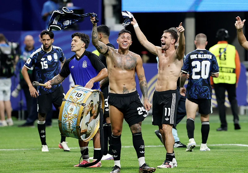Soccer Football - FIFA World Cup 2026 - Semi Final - England v Argentina - Atlanta Stadium, Atlanta, Georgia, U.S. - July 15, 2026
Argentina's Giovani Lo Celso, Lisandro Martinez and Enzo Fernandez celebrate with a Lionel Messi themed drum after the match as Argentina qualify for the final of the World Cup REUTERS/Amanda Perobelli