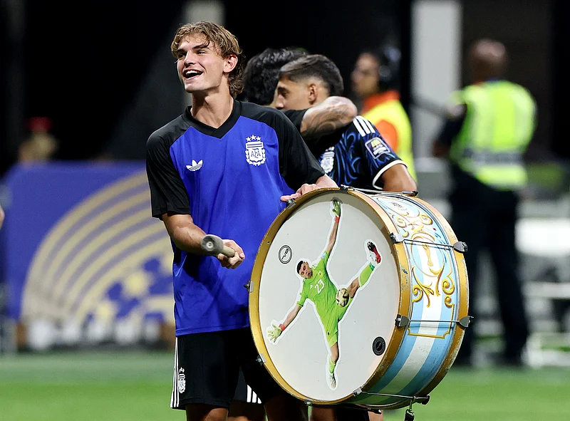 Soccer Football - FIFA World Cup 2026 - Semi Final - England v Argentina - Atlanta Stadium, Atlanta, Georgia, U.S. - July 15, 2026
Argentina's Nico Paz celebrates with a Emiliano Martinez themed drum after the match as Argentina qualify for the final of the World Cup REUTERS/Amanda Perobelli