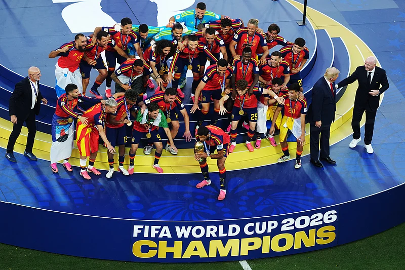 Soccer Football - FIFA World Cup 2026 - Final - Spain v Argentina - New York/New Jersey Stadium, East Rutherford, New Jersey, U.S. - July 19, 2026
Spain's Rodri lifts the World Cup trophy alongside teammates as they celebrate winning the World Cup next to U.S. President Donald Trump and FIFA President Gianni Infantino IMAGN IMAGES via Reuters/James Lang