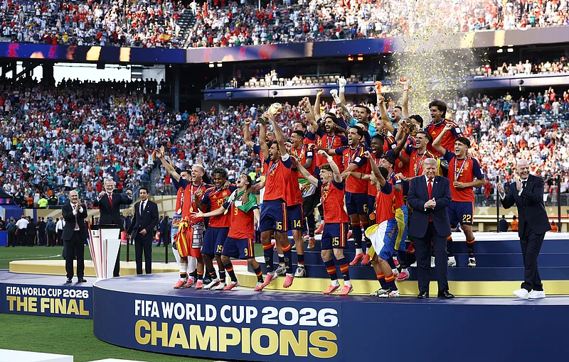 Soccer Football - FIFA World Cup 2026 - Final - Spain v Argentina - New York/New Jersey Stadium, East Rutherford, New Jersey, U.S. - July 19, 2026
Spain's Rodri lifts the World Cup trophy alongside teammates as they celebrate winning the World Cup with U.S. President Donald Trump and FIFA President Gianni Infantino REUTERS/Lee Smith