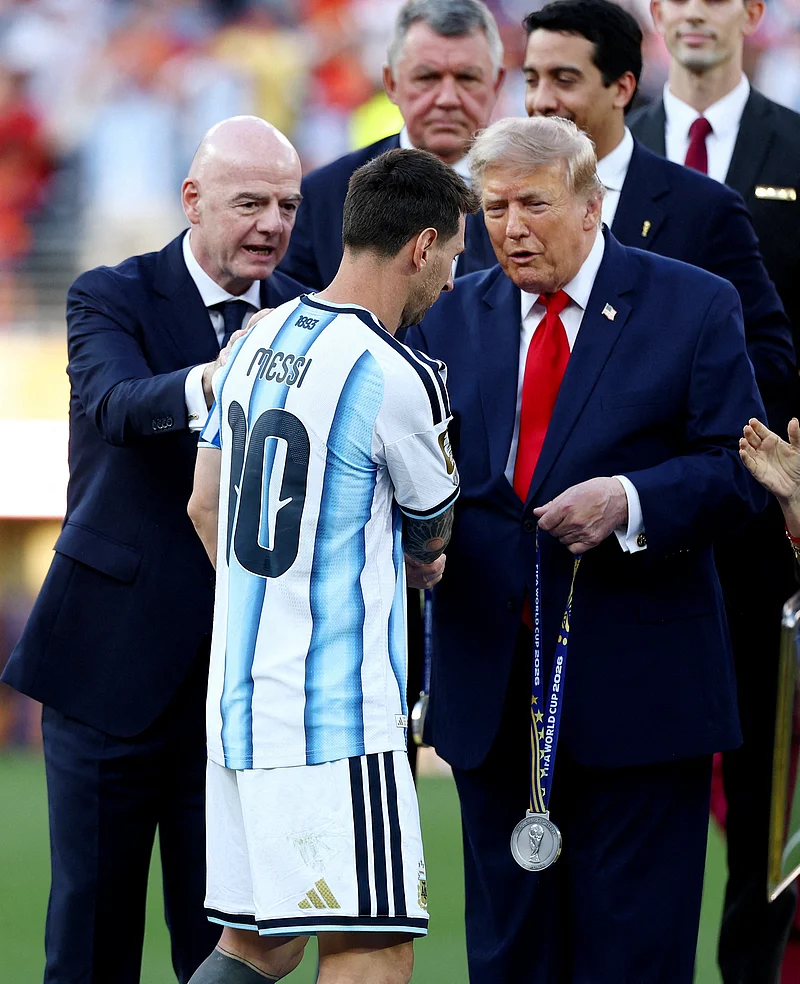 Soccer Football - FIFA World Cup 2026 - Final - Spain v Argentina - New York/New Jersey Stadium, East Rutherford, New Jersey, U.S. - July 19, 2026
Argentina's Lionel Messi is handed his runners up medal by U.S. President Donald Trump as FIFA President Gianni Infantino looks on REUTERS/Kai Pfaffenbach     TPX IMAGES OF THE DAY