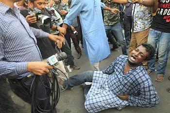 A Gonojagoron Moncho activist hurts at Shahbagh in Dhaka as police charge baton on them on Friday. Photo: Sajid Hossain