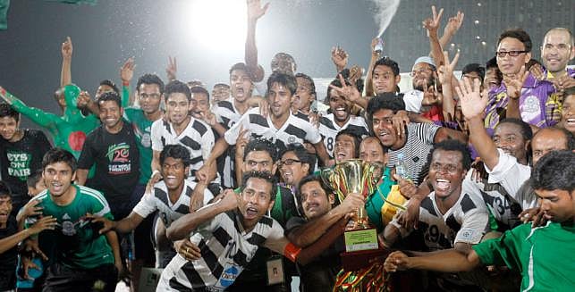 Mohammedan SC players celebrate at the podium with the trophy after winning Independence Cup football final match against Feni Soccer Club in Dhaka on Saturday. Photo: Shamsul Haque