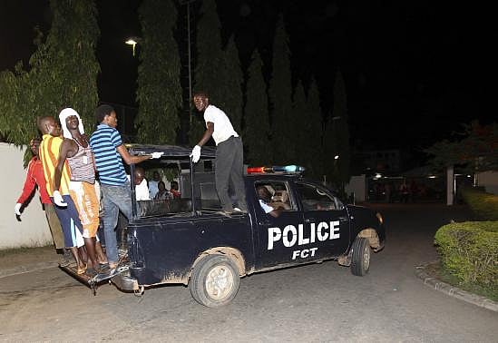Volunteer rescue workers travel on a police van used to evacuate victims after a bombing to Asokoro General Hospital in Abuja. Photo: Reuters