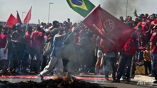 Members of the Workers Without a Roof Movement (MTST) protest near the Arena Corinthians stadium in Sao Paulo against the upcoming FIFA World Cup Brazil. Photo: AFP