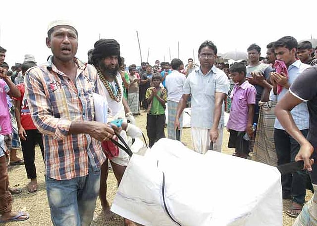Relatives of a ferry capsize victim take away the body for funeral works. The photo was taken form the accident site at Gazaria in Munshiganj on Saturday. Photo: Prothom Alo
