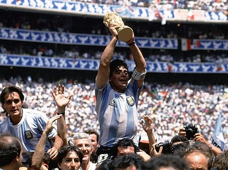 Argentine star Diego Maradona holds up the World Cup trophy as he is carried off the field after Argentina defeated West Germany 3-2 to win the World Cup in Mexico City on June 29, 1986. Photo: Reuters