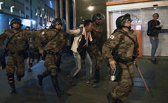 Riot police arrest a man during a demonstration against the FIFA World Cup in Belo Horizonte, Brazil on June 12, 2014. Photo: AFP