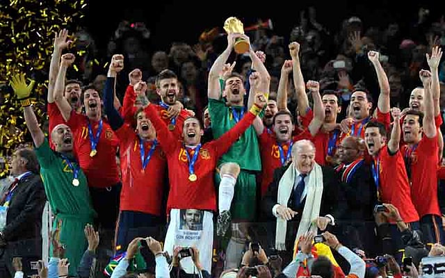 Spain's goalkeeper Iker Casillas (C) raises the trophy as Spain's national football team players celebrate with FIFA President Sepp Blatter (5thR) and South Africaâ€™s President Jacob Zuma (4thR) winning the 2010 World Cup football final Netherlands vs. Spain on July 11, 2010 at Soccer City stadium in Soweto, suburban Johannesburg. AFP