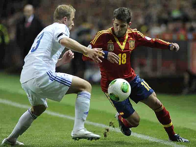 Spain's defender Jordi Alba (R) vies with Finland's defender Mikko Sumusalo (L) during the FIFA 2014 World Cup qualifier football match Spain vs Finland at the Molinon stadium in Gijon on March 22, 2013. AFP