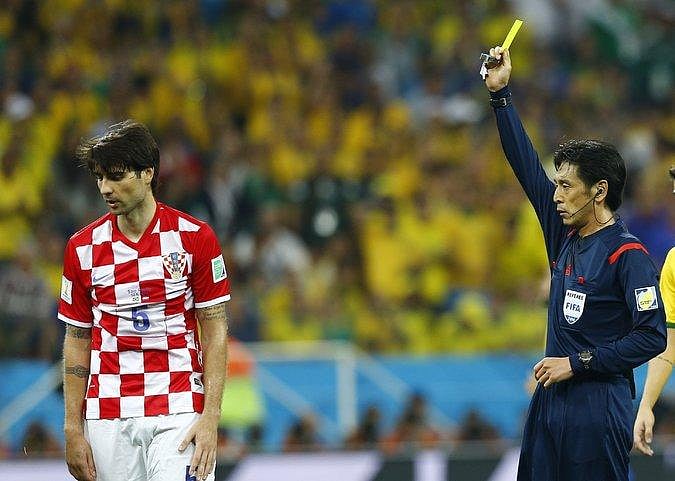 World Cup referee Yuichi Nishimura shows a yellow card to Vedran Corluka of Croatia. Photo: Reuters