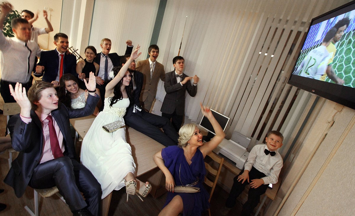 Belarus school-leavers shouts as they watch the opening football match Brazil vs Croatia of the 2014 FIFA World Cup on June 12, 2014 during their school-leaving party in Minsk. Photo: AFP
