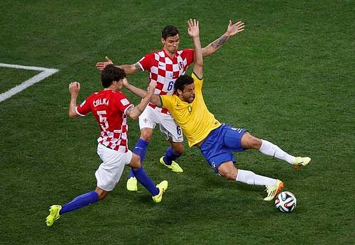 Brazil's Fred is fouled by Croatia's Dejan Lovren inside the area during their 2014 World Cup opening match at the Corinthians arena in Sao Paulo June 12, 2014.  Photo: Reuters