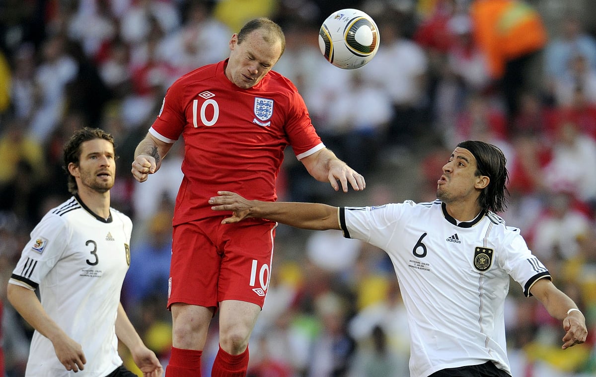 England's striker Wayne Rooney (C) heads the ball past Germany's defender Arne Friedrich (L) and Germany's midfielder Sami Khedira during the 2010 World Cup round of 16 football match against Germany on June 27, 2010 at Free State stadium in Mangaung. AFP