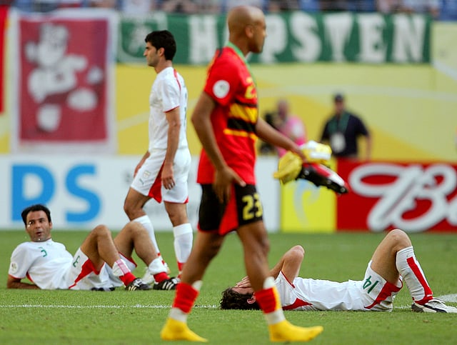 Angolan defender Marco Abreu (23), Iranian defender Sohrab Bakhtiarizadeh (3), Iranian midfielder Andranik Teymourian (14) look dejected at the end of the World Cup 2006 group D football match Iran vs Angola, 21 June 2006 at Leipzig stadium. Match ended 1-1. AFP