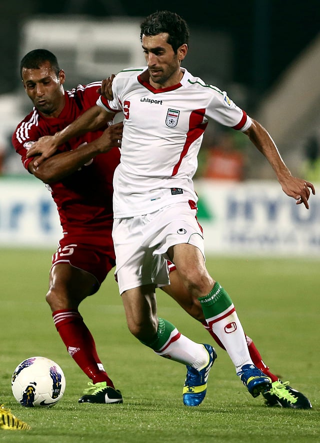 Iran's midfielder Mojtaba Jabari (R) dribbles past Lebanon's midfielder Hamzeh Salameh (L) during their 2014 World Cup Asian zone group A qualifying football match at Azadi Stadium in Tehran on June 11, 2013. AFP