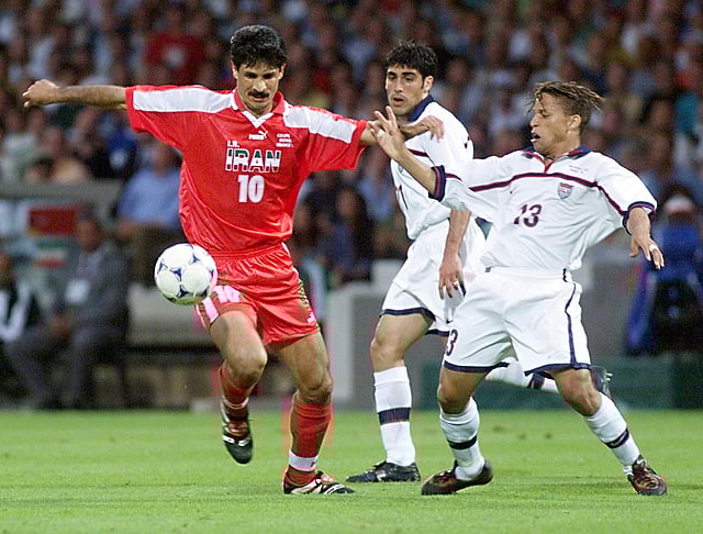Iranian forward Ali Daei (L) is challenged by US midfielder Cobi Jones as Claudio Reyna looks on (C) 21 June at the Gerland stadium in Lyon, central France, during the 1998 Soccer World Cup Group F first round second match between Iran and the United States. AFP