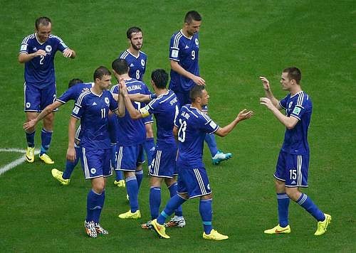 Bosnia's Avdija Vrsajevic (2) celebrates with teammates after scoring his team's third goal during their 2014 World Cup Group F soccer match against Iran at the Fonte Nova arena in Salvador June 25, 2014. Photo: Reuters