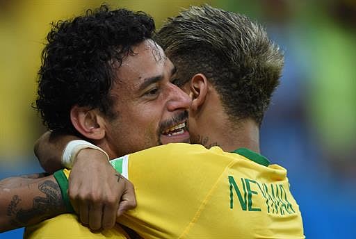 Brazil's forward Fred (L) celebrates with Brazil's forward Neymar after scoring during a Group A football match between Cameroon and Brazil at the Mane Garrincha National Stadium in Brasilia during the 2014 FIFA World Cup on June 23, 2014. AFP
