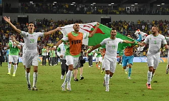 Algerian players celebrate at the end of their Group H football match against Russia at the Baixada Arena in Curitiba during the 2014 FIFA World Cup on June 26, 2014. AFP