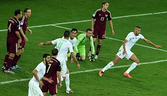 Algeria's forward Islam Slimani (R/13#) celebrates after heading to score a goal past Russia's goalkeeper Igor Akinfeev (3R) during the Group H football match between Algeria and Russia at The Baixada Arena in Curitiba on June 26, 2014, during the 2014 FIFA World Cup. AFP