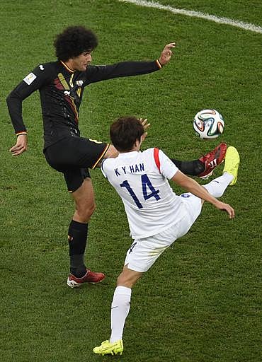 Belgium's midfielder Marouane Fellaini (L) vies with South Korea's midfielder Han Kook-Young during a Group H football match between South Korea and Belgium at the Corinthians Arena in Sao Paulo during the 2014 FIFA World Cup on June 26, 2014. AFP