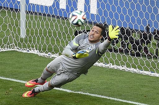 Brazil's goalkeeper Julio Cesar save a shot in goal by Chile's defender Gonzalo Jara during the penalty shoot out after extra-time in the Round of 16 football match between Brazil and Chile at The Mineirao Stadium in Belo Horizonte during the 2014 FIFA World Cup on June 28, 2014. AFP