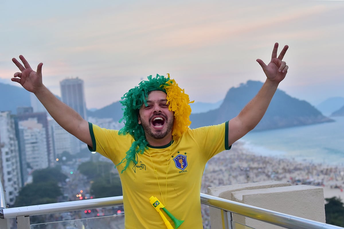 A fan of Brazil celebrates on a terrace in Copacabana, Rio de Janeiro on June 28, 2014, after the Round of 16 football match at the Mineirao Stadium in Belo Horizonte. Photo: AFP