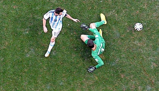 Belgium's goalkeeper Thibaut Courtois saves the ball from Argentina's Lionel Messi (L) during their 2014 World Cup quarter-finals at the Brasilia national stadium in Brasilia on July 5, 2014. Reuters