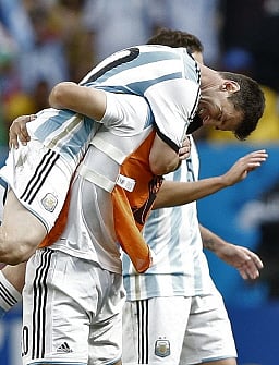 Argentina's forward and captain Lionel Messi (L) celebrates with team mates after winning the quarter-final football match between Argentina and Belgium at the Mane Garrincha National Stadium in Brasilia during the 2014 FIFA World Cup on July 5, 2014. AFP
