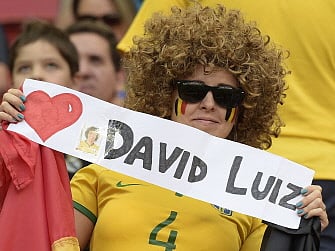A fan holds a sign for Brazil's player Daivd Luiz during a quarter-final football match between Argentina and Belgium at the Mane Garrincha National Stadium in Brasilia during the 2014 FIFA World Cup on July 5, 2014. AFP