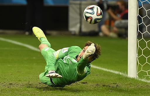 Netherlands' goalkeeper Tim Krul saves a penalty by Costa Rica's defender Michael Umana during the penalty shootout after the extra time in the quarter-final football match between Netherlands and Costa Rica at the Fonte Nova Arena in Salvador during the 2014 FIFA World Cup on July 5, 2014. AFP