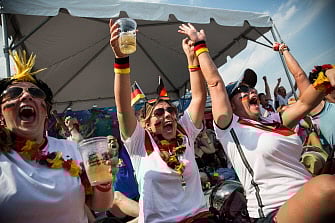Oona Hodos, Nathalie Dorner and Natascha Cozby celebrate after a German goal in the Germany vs Brazil semi-final World Cup game on July 8, 2014 in New York City. Germany scored an unprecendented five unanswered goals in the first half of the game. AFP