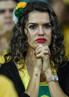 A fan of Brazil gestures during the Brazil 2014 FIFA World Cup semifinal match Brazil vs Germany, outside the Mineirao Stadium in Belo Horizonte, on July 8, 2014. AFP