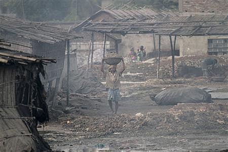 A worker carries tannery wastes at Hazaribagh in Dhaka October 9, 2012. Reuters