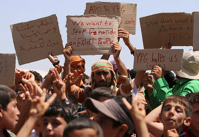 Refugees from the Iraqi minority Yazidi sect at Nowruz refugee camp in northeastern Syria on 17 August  2014 take part in a protest to call for their evacuation from the Middle East and an end to the violence against their community. Photo: Reuters