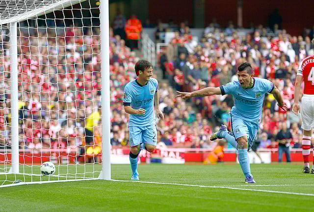 Manchester City's Sergio Aguero (R) celebrates after scoring a goal against Arsenal during their English Premier League soccer match at the Emirates stadium in London on September 13, 2014. Reuters