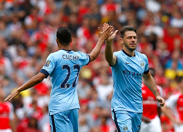 Manchester City's Martin Demichelis (R) celebrates with teammate Gael Clichy after scoring a goal against Arsenal during their English Premier League soccer match at the Emirates stadium in London on September 13, 2014. Reuters