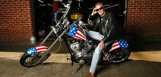 Peter Fonda poses for photo riding 'Captain America', a chooper-style motorbike used in the 1969 classic film 'Easy Rider'. Photo: Reuters