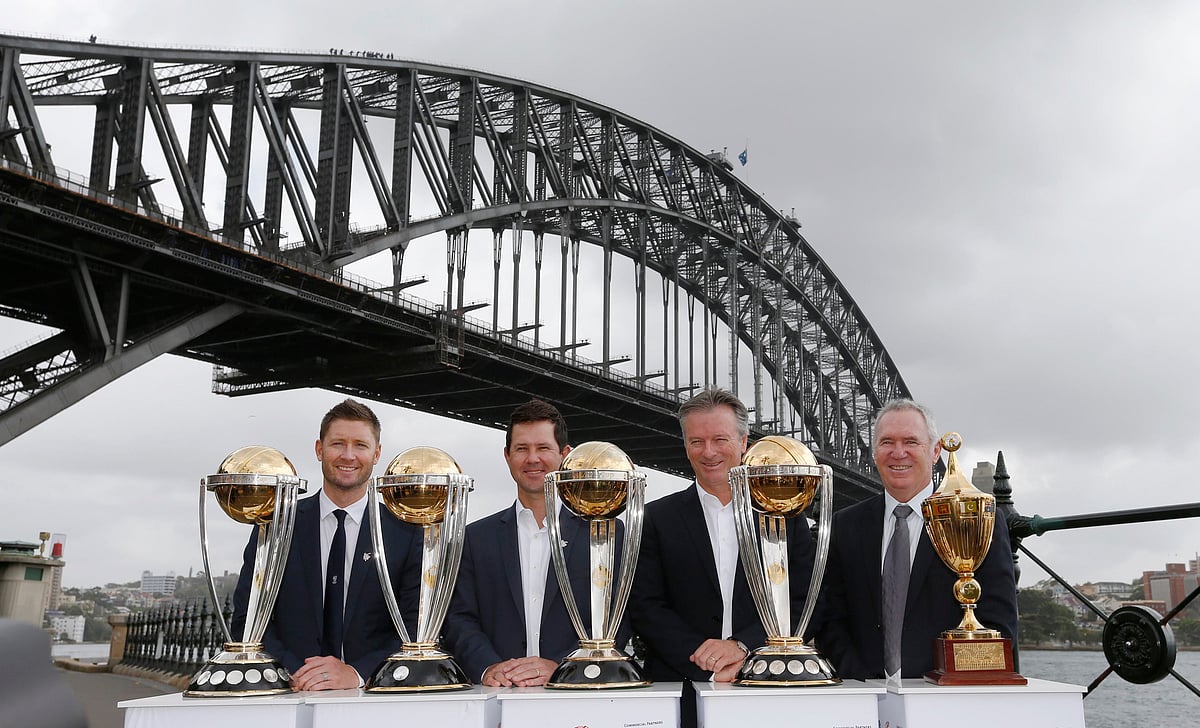 Australian cricket team captain Michael Clarke (L) gathers with Australian Cricket World Cup-winning captains (2nd L-R) Ricky Ponting, Steve Waugh and Allan Border as they pose with their previous World Cup trophies to mark the 100-day countdown to the 2015 Cricket World Cup in Sydney November 6, 2014. Reuters